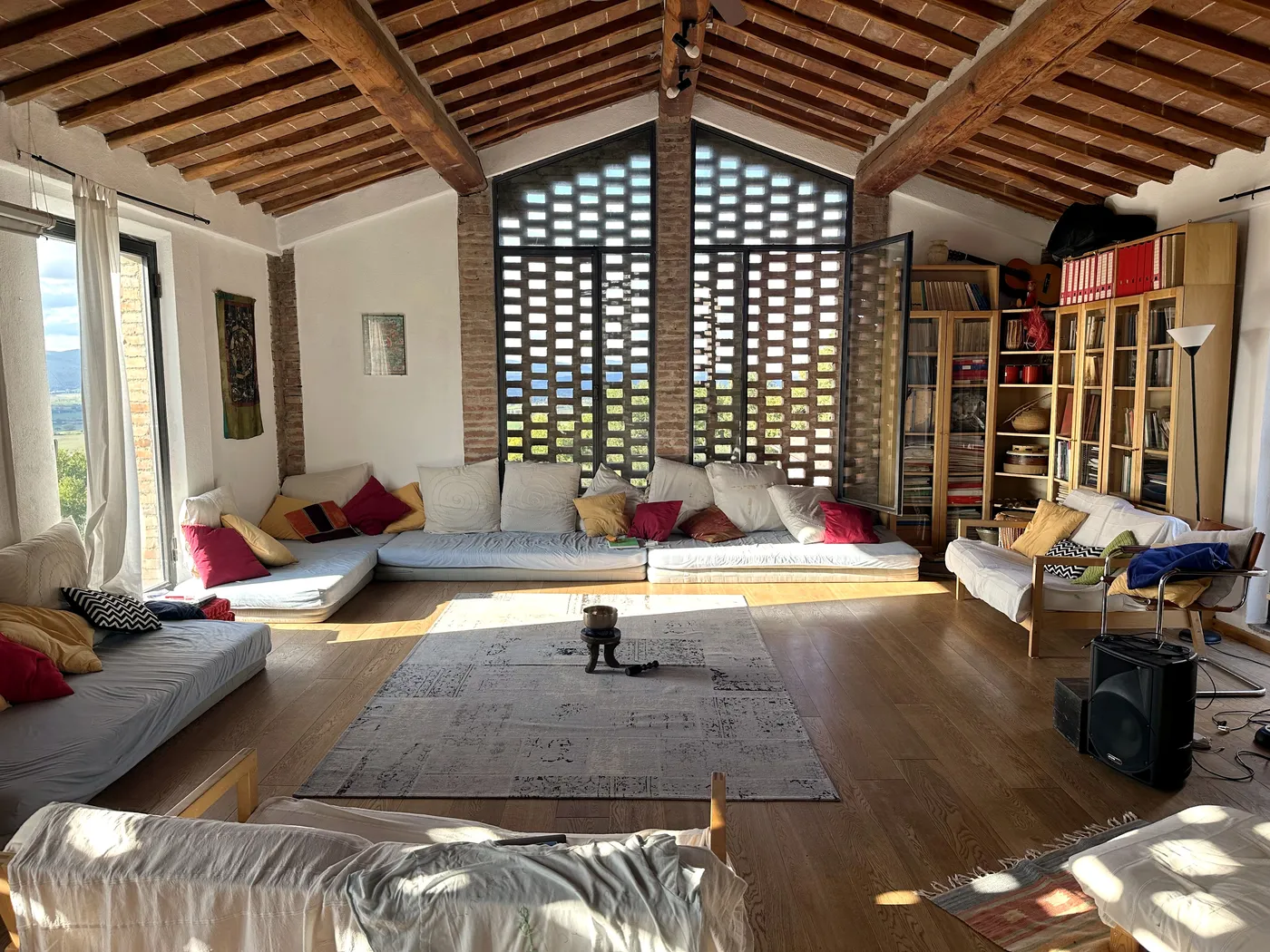 Il salone con il soffitto in travi e le grandi finestre